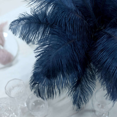 Navy blue feather plant arrangement on a minimalist surface
