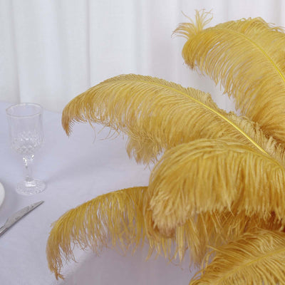 Yellow feather decorations on a table with glassware and cutlery.