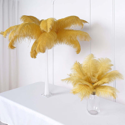 Yellow feather decorative trees on a white table.