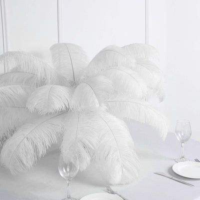 White feather centerpiece with elegant table setting.