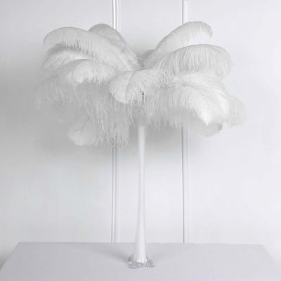 White feather palm tree decoration on a plain backdrop