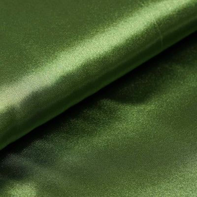 Shiny green satin fabric folded in layers.