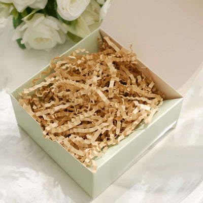 Brown crinkle paper filler in a light green gift box.