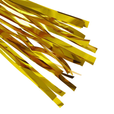 Gold metallic streamers on a white background
