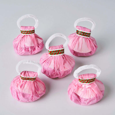 Pink paper streamers in five decorative bags with white handles