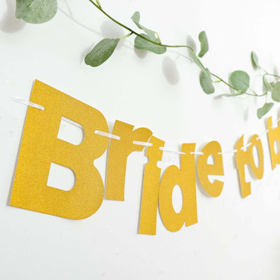 Gold "Bride to Be" banner with greenery