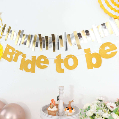 Gold "Bride to be" banner with decorative accents for wedding celebrations.