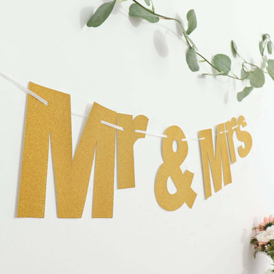 Gold "Mr & Mrs" banner decoration for weddings or celebrations.