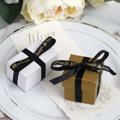 Elegant gift boxes with black ribbons and personalized tags on a decorative plate.