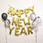 Gold "Happy New Year" balloons with black and white marbled balloons.