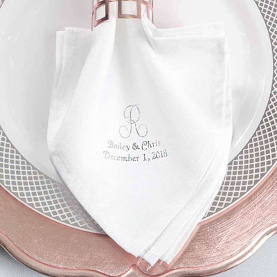 Personalized white linen napkin with embroidered initials and date.