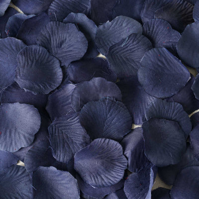 Navy blue silk flower petals scattered on a surface.