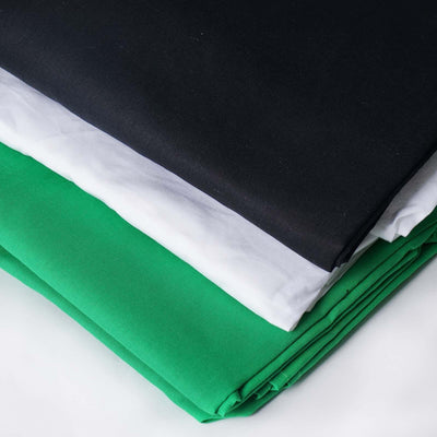 Stack of black, white, and green fabrics neatly folded.