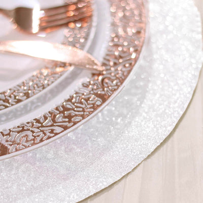 Rose gold decorative plate with intricate design on a sparkling white background.