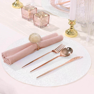 Elegant table setting with pink napkins and rose gold cutlery.