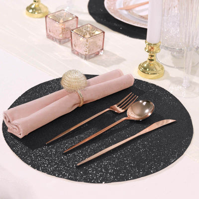 Elegant black glitter placemat with rose gold cutlery and napkin.