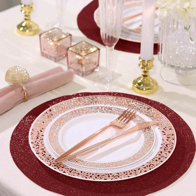 Elegant dinner setting with gold cutlery and decorative plates on a festive table.