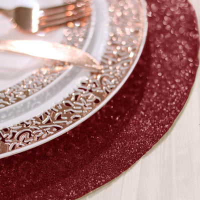 Elegant burgundy table setting with decorative plates and cutlery.