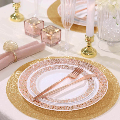 Elegant rose gold dinnerware set with decorative plates and utensils on a festive table.