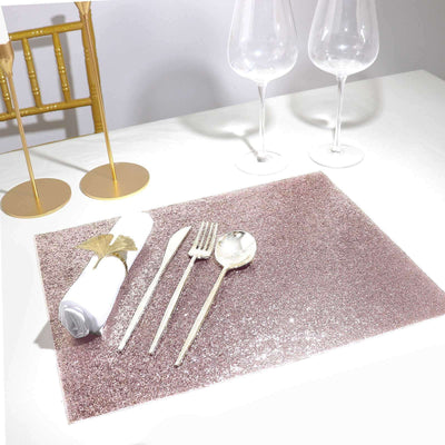 Rose gold glitter placemat with cutlery and napkin on a table setting.