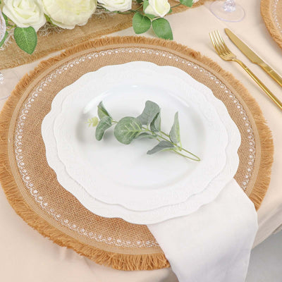 Elegant white plate with greenery on a rustic burlap charger.