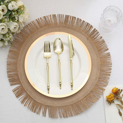 Elegant table setting with gold cutlery on a textured beige placemat.