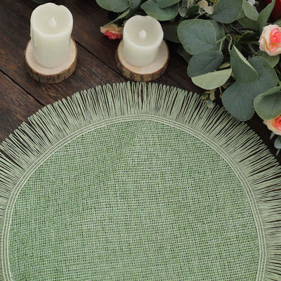 Green round placemat with fringe detail, surrounded by candles and greenery.