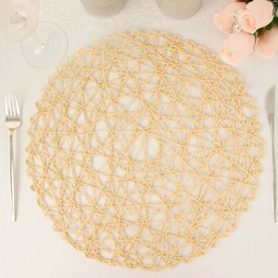 Round woven placemat in natural fibers on a white table setting.