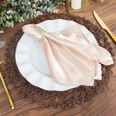 Elegant beige napkin on a white plate with decorative woven placemat.