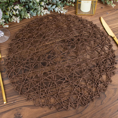 Brown woven placemat on a wooden table with elegant dining setup.