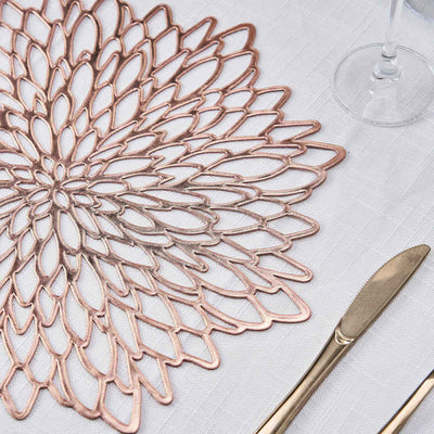 Rose gold floral table placemat on a textured white tablecloth.