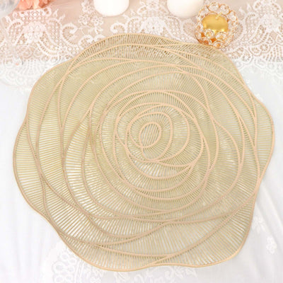 Decorative gold rose-shaped placemat on lace tablecloth.