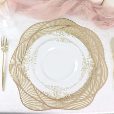 Elegant gold-trimmed plate on a decorative charger with silverware set.