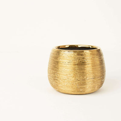 Gold textured decorative bowl on a white background.