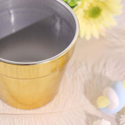 Gold metal flower pot with a shiny finish.
