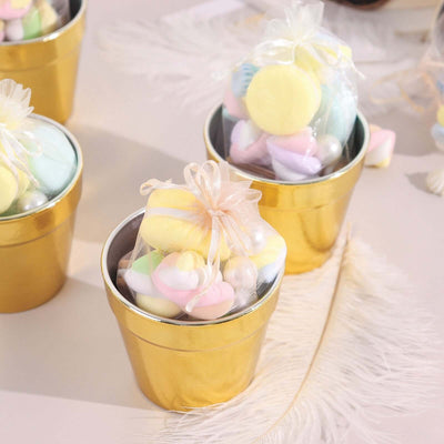 Colorful pastel candies in gold pots with sheer bows.