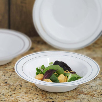 White serving bowl with salad on a granite countertop.