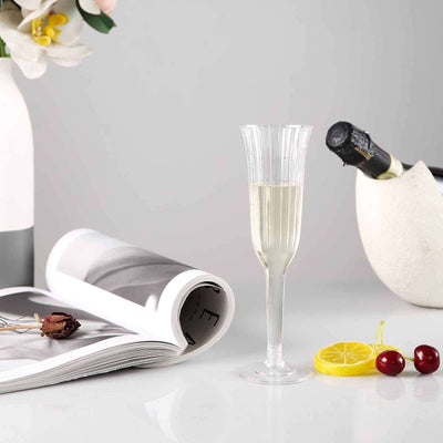 Elegant champagne flute with lemon slice and cherries, styled with magazine and decor.