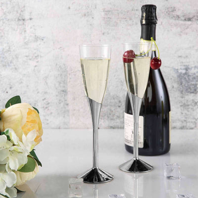 Elegant champagne flutes with cherries, sparkling wine, and flowers in a festive setting.