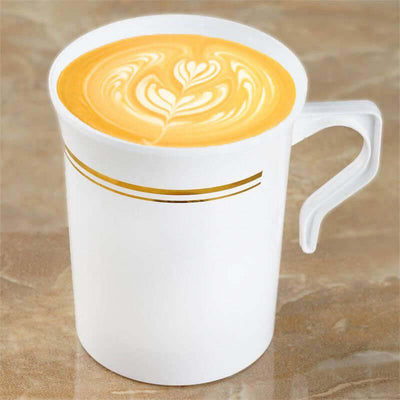 White coffee mug with latte art design on a marble surface.