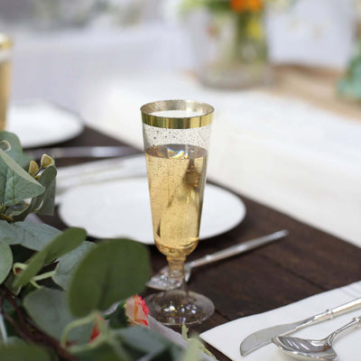 Elegant gold-rimmed champagne flute on a beautifully set table.