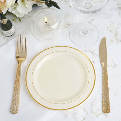 Elegant gold-accented dinnerware set with plate, fork, and knife.