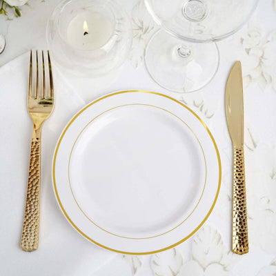 Elegant gold-accented table setting with plate, fork, and knife.