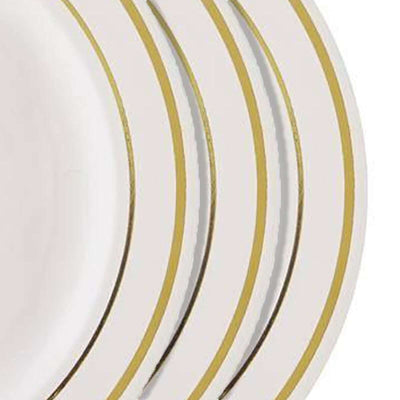 Set of elegant white plates with gold trim.