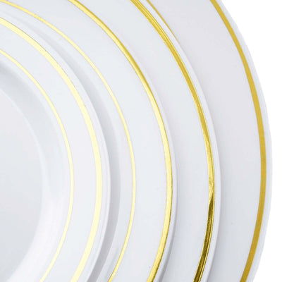 White plates with gold trim stacked together.
