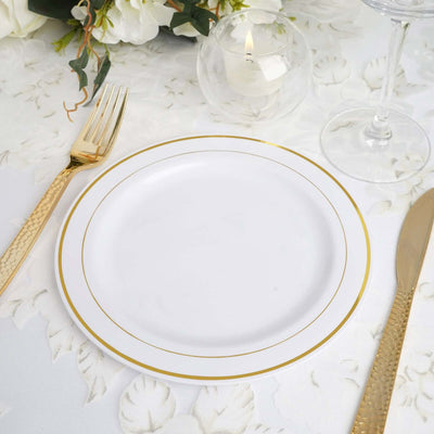 Elegant white plate with gold trim, set on a floral tablecloth.