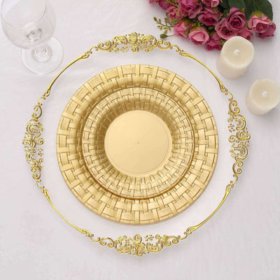 Elegant golden dinnerware set arranged on a white table with floral accents.