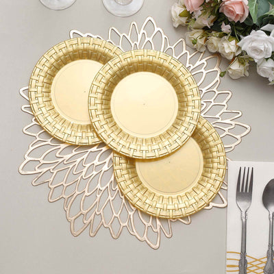 Gold decorative plates arranged on a lace table mat with silver cutlery.