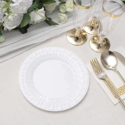 White decorative plate with a textured rim, styled for an elegant table setting.