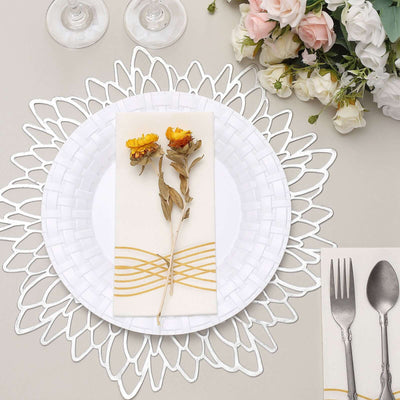 Elegant table setting with a decorative plate, floral napkin, and utensils.